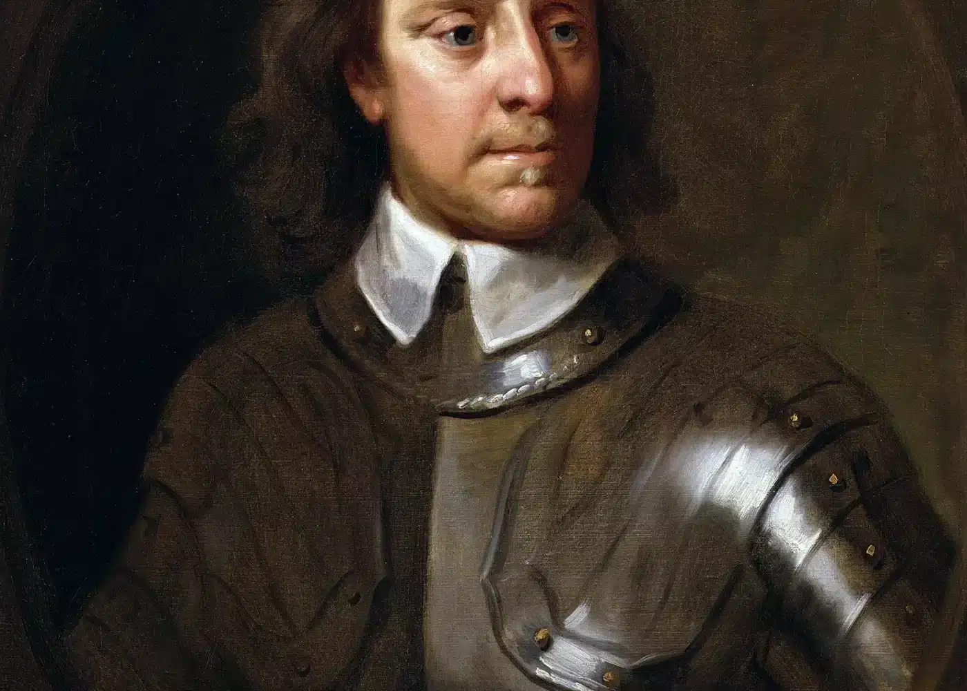 Portrait of Oliver Cromwell, showing him in armour with white fabric collar underneath, against a dark backdrop.