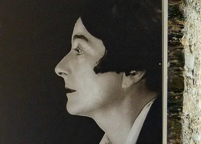 Black and white side-profile portrait photograph of Eileen Gray against a dark background, featured in Enniscorthy Castle.