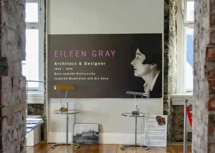 Exhibit panel inside Enniscorthy Castle featuring Eileen Gray’s photograph, displayed alongside examples of her modernist furniture designs.