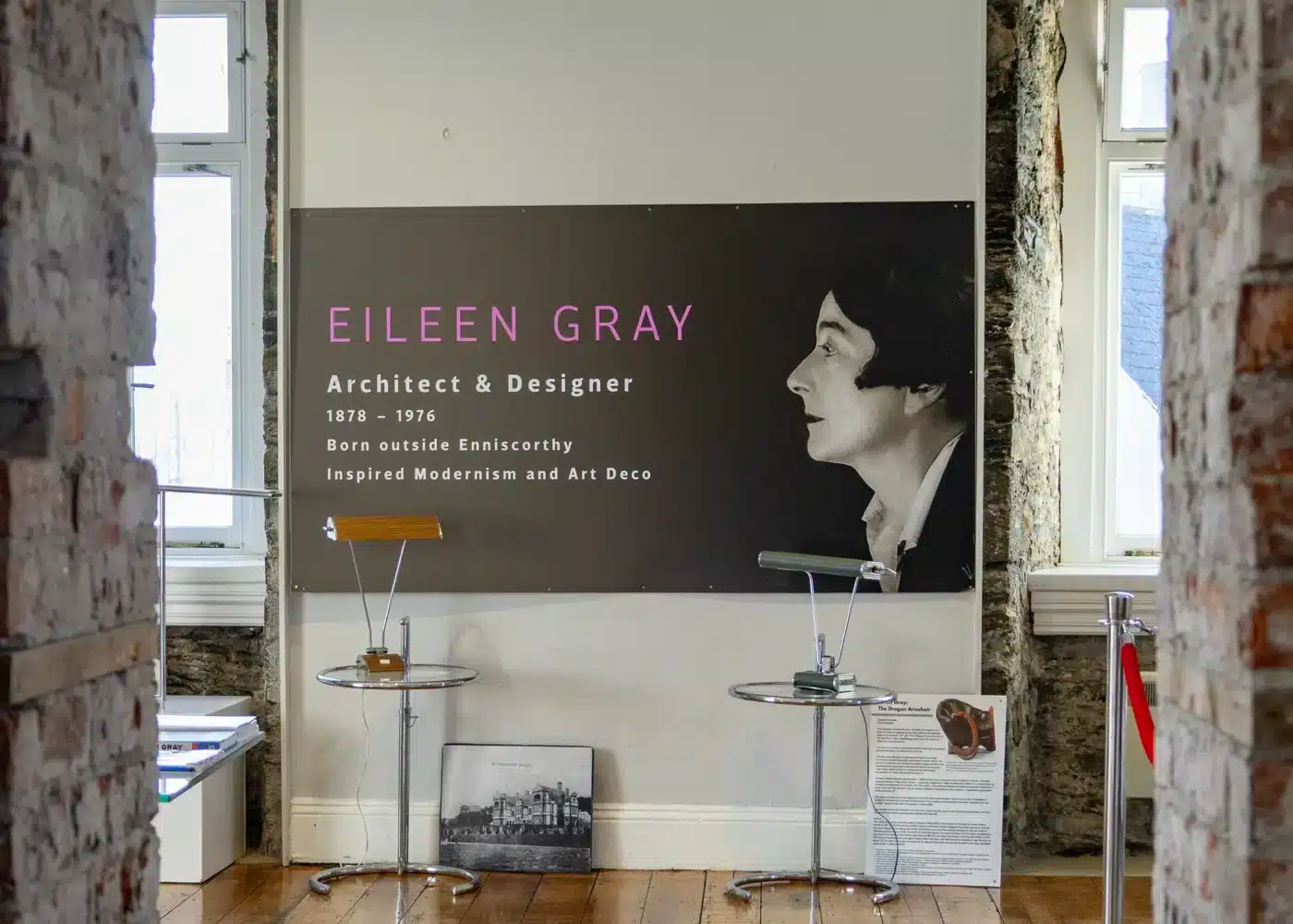 Exhibit panel inside Enniscorthy Castle featuring Eileen Gray’s photograph, displayed alongside examples of her modernist furniture designs.