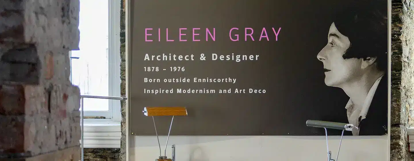 Exhibit panel inside Enniscorthy Castle featuring Eileen Gray’s photograph, displayed alongside examples of her modernist furniture designs.