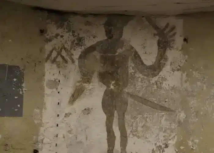 Photo of medieval swordsman graffiti, showing man with weapons drawn on stone, featured in Enniscorthy Castle.