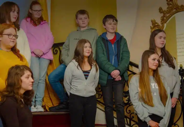 Group of young people standing together inside the National 1798 Rebellion Centre.