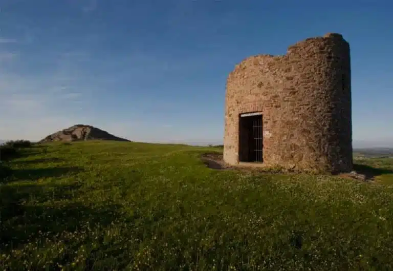 Stone watchtower on Vinegar Hill in Enniscorthy, with grassy slopes and a clear blue sky in the background.